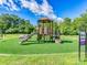 Community playground featuring a slide, climbing structure and artificial grass surfacing at 208 Armstrong Dr, Belmont, NC 28012