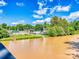 Scenic riverfront view showcasing lush greenery, buildings, and the calm river at 208 Armstrong Dr, Belmont, NC 28012