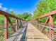 Picturesque walking bridge surrounded by lush trees, providing a peaceful outdoor experience at 208 Armstrong Dr, Belmont, NC 28012