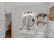 Updated bathroom with modern vanity, black accents, wood shelves, and a walk-in shower at 2113 Woodlawn St, Kannapolis, NC 28083
