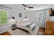 Bright bedroom with white walls, hardwood floors, ceiling fan, two windows and neutral decor at 2113 Woodlawn St, Kannapolis, NC 28083