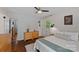 Light bedroom with hardwood floors, white walls, dresser, and outdoor view with a window and door at 2113 Woodlawn St, Kannapolis, NC 28083