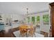 Well-lit dining area with wood floors, sliding glass doors, and an adjacent breakfast bar at 2113 Woodlawn St, Kannapolis, NC 28083