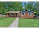 Charming brick home featuring a walkway leading to the front door and a well-manicured lawn at 2113 Woodlawn St, Kannapolis, NC 28083