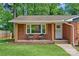 Inviting front porch with brick facade, wooden pillars and charming chairs at 2113 Woodlawn St, Kannapolis, NC 28083