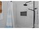 Clean, updated bathroom with a tiled shower, niche, and modern fixtures at 2113 Woodlawn St, Kannapolis, NC 28083