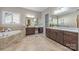 Spacious bathroom with dual vanities, a soaking tub, travertine floors, and plenty of counter space at 212 Seven Oaks Lndg, Belmont, NC 28012