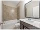 This bathroom features a single sink vanity, tile surround tub/shower combo, and tiled floors at 212 Seven Oaks Lndg, Belmont, NC 28012