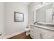 Elegant half-bath with modern fixtures, a framed mirror, a gray countertop, and hardwood floors at 212 Seven Oaks Lndg, Belmont, NC 28012