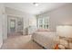 Cozy bedroom features a large window, shutters, and an adjacent room through an open door at 212 Seven Oaks Lndg, Belmont, NC 28012