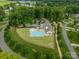 Aerial view of community pool and clubhouse, surrounded by lush landscaping at 212 Seven Oaks Lndg, Belmont, NC 28012