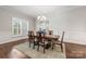 Formal dining room with elegant table, six chairs and decorative wainscoting at 212 Seven Oaks Lndg, Belmont, NC 28012