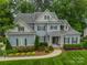 Charming home featuring a landscaped front yard, shuttered windows, and a welcoming front porch at 212 Seven Oaks Lndg, Belmont, NC 28012