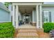 Charming front porch with classic columns and a cozy seating area at 212 Seven Oaks Lndg, Belmont, NC 28012