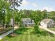 Beautiful two story home with a large front yard and well manicured landscaping, with mature trees at 212 Seven Oaks Lndg, Belmont, NC 28012