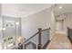Bright hallway with staircase showcasing natural light and neutral tones, leading to the front entrance at 212 Seven Oaks Lndg, Belmont, NC 28012