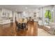 An open-concept kitchen with white cabinets, granite countertops, and a breakfast nook at 212 Seven Oaks Lndg, Belmont, NC 28012