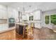 A modern kitchen with a granite island, pendant lighting, and stainless steel appliances at 212 Seven Oaks Lndg, Belmont, NC 28012