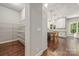 View of kitchen with an island and dining table, stainless steel appliances, and wood floors from pantry at 212 Seven Oaks Lndg, Belmont, NC 28012