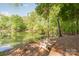 Scenic view of the lakeside with Adirondack chairs, offering a peaceful retreat at 212 Seven Oaks Lndg, Belmont, NC 28012
