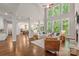 Spacious living room with high ceilings, large windows, hardwood floors, and open access to the kitchen at 212 Seven Oaks Lndg, Belmont, NC 28012