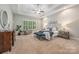 Serene main bedroom featuring a tray ceiling, sitting area, and plenty of natural light from the window at 212 Seven Oaks Lndg, Belmont, NC 28012