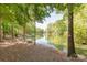 Tranquil waterfront view featuring a scenic pond with inviting seating, perfect for relaxing at 212 Seven Oaks Lndg, Belmont, NC 28012