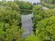 A calm pond is surrounded by lush greenery, creating a serene, natural escape at 212 Seven Oaks Lndg, Belmont, NC 28012