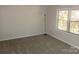 Bedroom with a light colored carpet, a window, and a floor lamp at 214 Idlewood Dr, Kannapolis, NC 28083