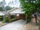 Exterior featuring covered carport, mature trees, and well-maintained landscaping at 214 Idlewood Dr, Kannapolis, NC 28083