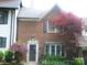 Brick home exterior featuring a decorative red Japanese Maple with lush landscaping at 214 Idlewood Dr, Kannapolis, NC 28083