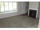 Inviting living room with plush carpeting, a fireplace, and bright natural light at 214 Idlewood Dr, Kannapolis, NC 28083