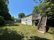 View of the house and wooden deck overlooking a spacious, green backyard at 2434 Columbus Cir, Charlotte, NC 28208