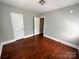 Bedroom featuring hardwood floors, light grey walls, white trim, and bright natural light at 2434 Columbus Cir, Charlotte, NC 28208