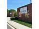 An inviting brick building showcases the Legion Friends & Beer sign against a backdrop of greenery at 2434 Columbus Cir, Charlotte, NC 28208