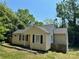 Charming single-story home with neutral siding, dark shutters and roof, and a partially wooded lot at 2434 Columbus Cir, Charlotte, NC 28208
