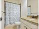This bathroom offers a granite vanity, decorative shower curtain, and provides a comfortable and stylish space at 258 Iverson Way, Charlotte, NC 28203