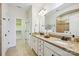 Elegant bathroom with double sinks, granite countertops, and a walk-in closet at 258 Iverson Way, Charlotte, NC 28203
