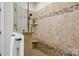 This beautiful bathroom features tiled walls, a rainfall shower head, and granite countertops at 258 Iverson Way, Charlotte, NC 28203