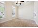 Bright bedroom with two windows, ceiling fan, neutral walls, and plush carpet providing a relaxing space at 258 Iverson Way, Charlotte, NC 28203