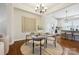 Stylish dining area with a round table, open to the kitchen, and hardwood floors at 258 Iverson Way, Charlotte, NC 28203