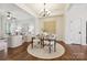 Elegant dining area with modern chandelier, hardwood floors, and open floor plan at 258 Iverson Way, Charlotte, NC 28203