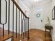 A welcoming foyer featuring hardwood floors, elegant staircase, and a stylish console table for a graceful entry at 258 Iverson Way, Charlotte, NC 28203
