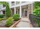 Stylish front entrance with stone accents, a covered porch and manicured landscaping at 258 Iverson Way, Charlotte, NC 28203