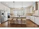 Bright kitchen featuring a large island with seating, stainless steel appliances, and stylish pendant lighting at 258 Iverson Way, Charlotte, NC 28203