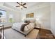 Comfortable main bedroom featuring a tray ceiling and carpet at 258 Iverson Way, Charlotte, NC 28203