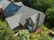 Aerial view of a brick and siding home with a well-maintained roof, surrounded by mature trees at 2825 Redfield Dr, Charlotte, NC 28270