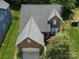 Aerial view showcases the brick home with a spacious garage and well-kept landscaping at 2825 Redfield Dr, Charlotte, NC 28270