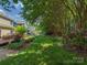 Beautifully landscaped backyard with lush greenery and mature trees, offering a serene outdoor space at 2825 Redfield Dr, Charlotte, NC 28270