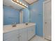 Bathroom featuring double vanity, a large mirror, and bright blue paint at 2825 Redfield Dr, Charlotte, NC 28270